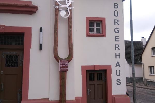 Das Foto zeigt die haushohe Stimmgabel an der Hausfassade des Bürgerhauses von Elchesheim-Illingen